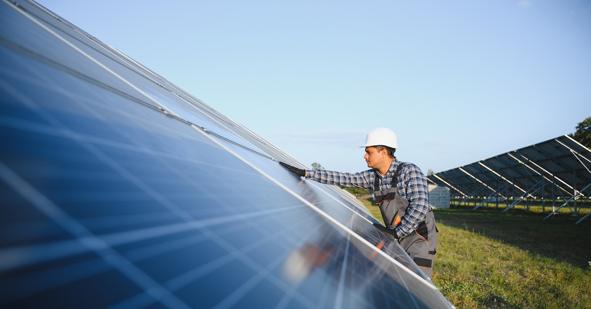 man working on solar panels