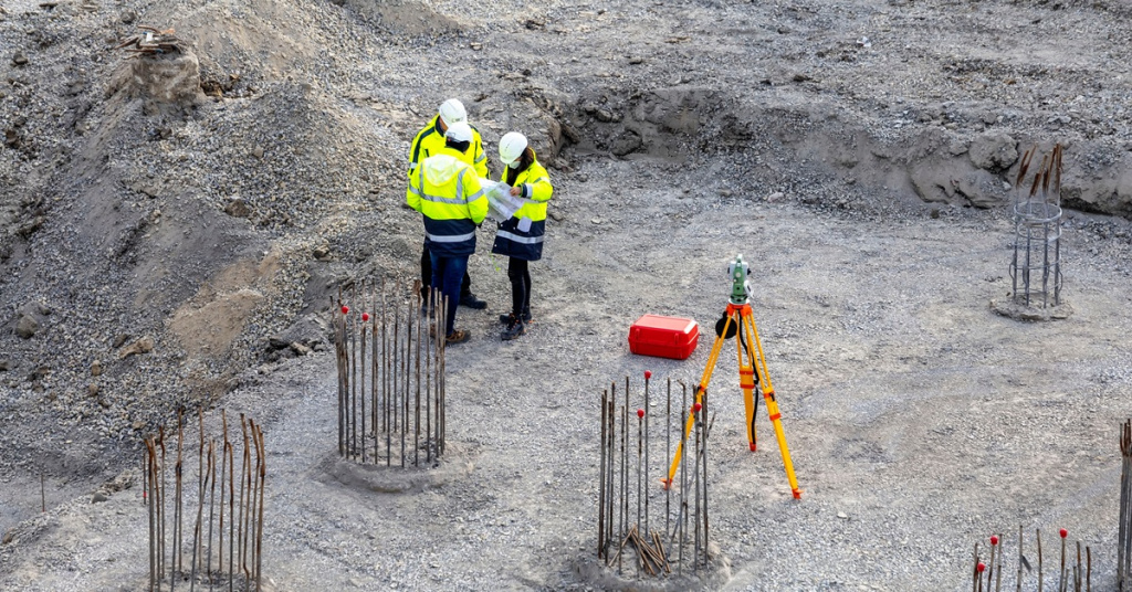 workers discussing plan on construction site