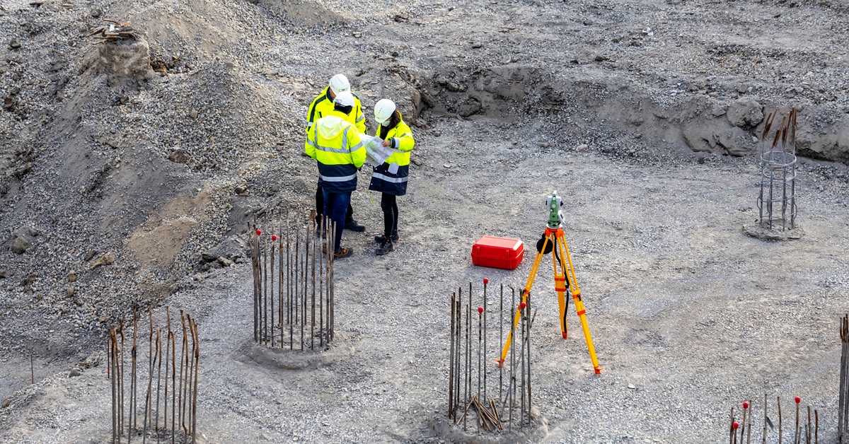 workers discussing plan on construction site